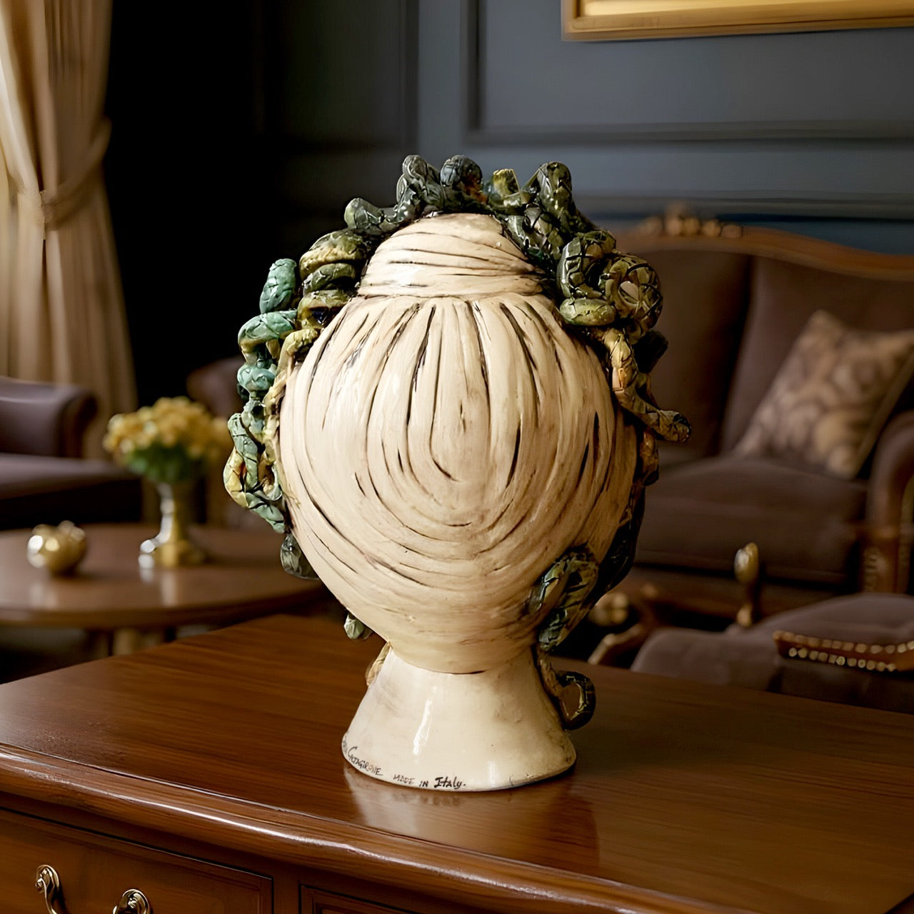 Handcrafted ceramic Testa di Moro vase with intricate detail, displayed on a wooden table.