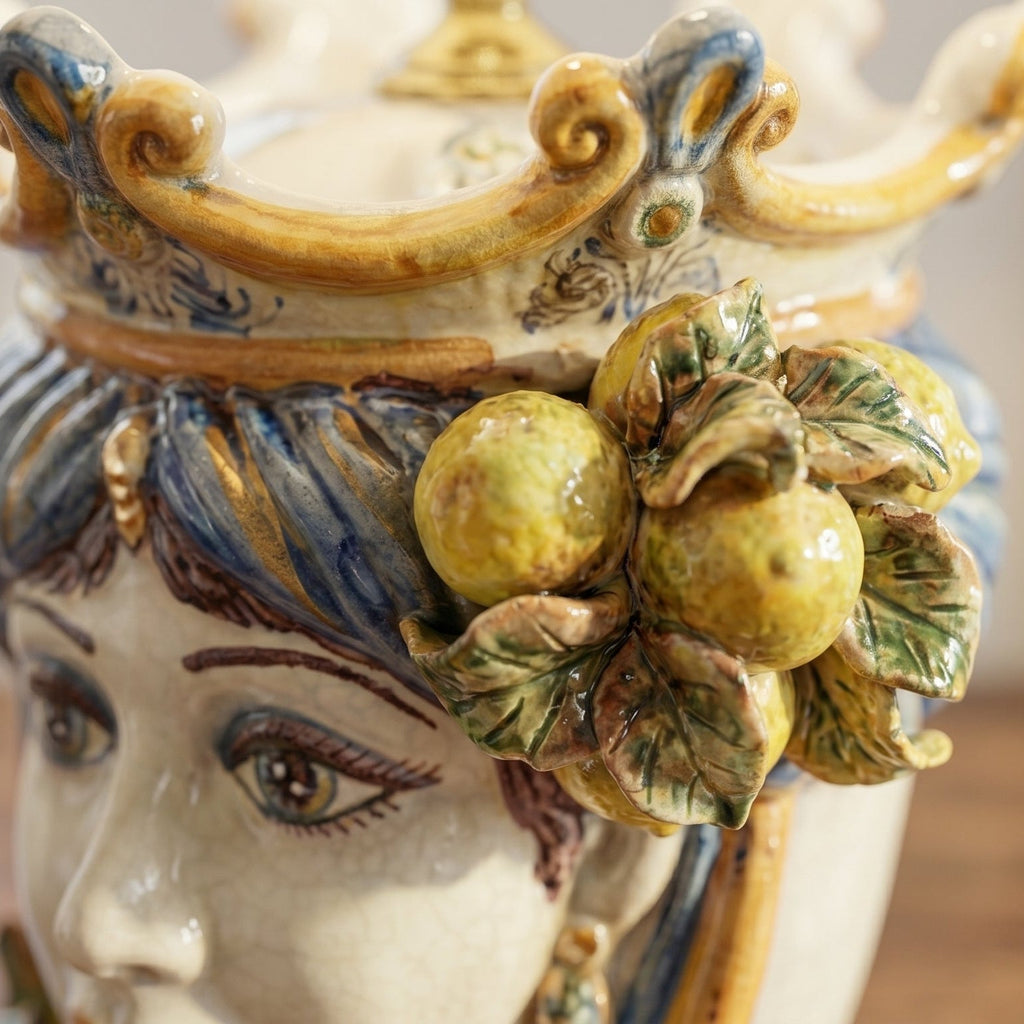 Handcrafted Teste di Moro ceramic vase with detailed face, citrus fruit, and leaf accents, blending tradition and modern design.