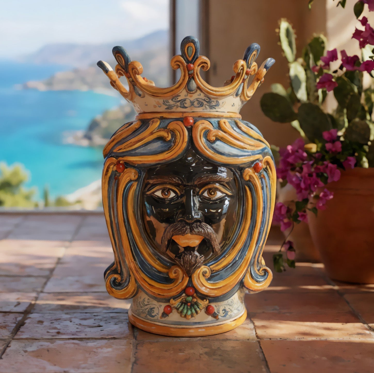 Handcrafted Teste di Moro ceramic vase with crown, vibrant colors, set on terrace with sea view