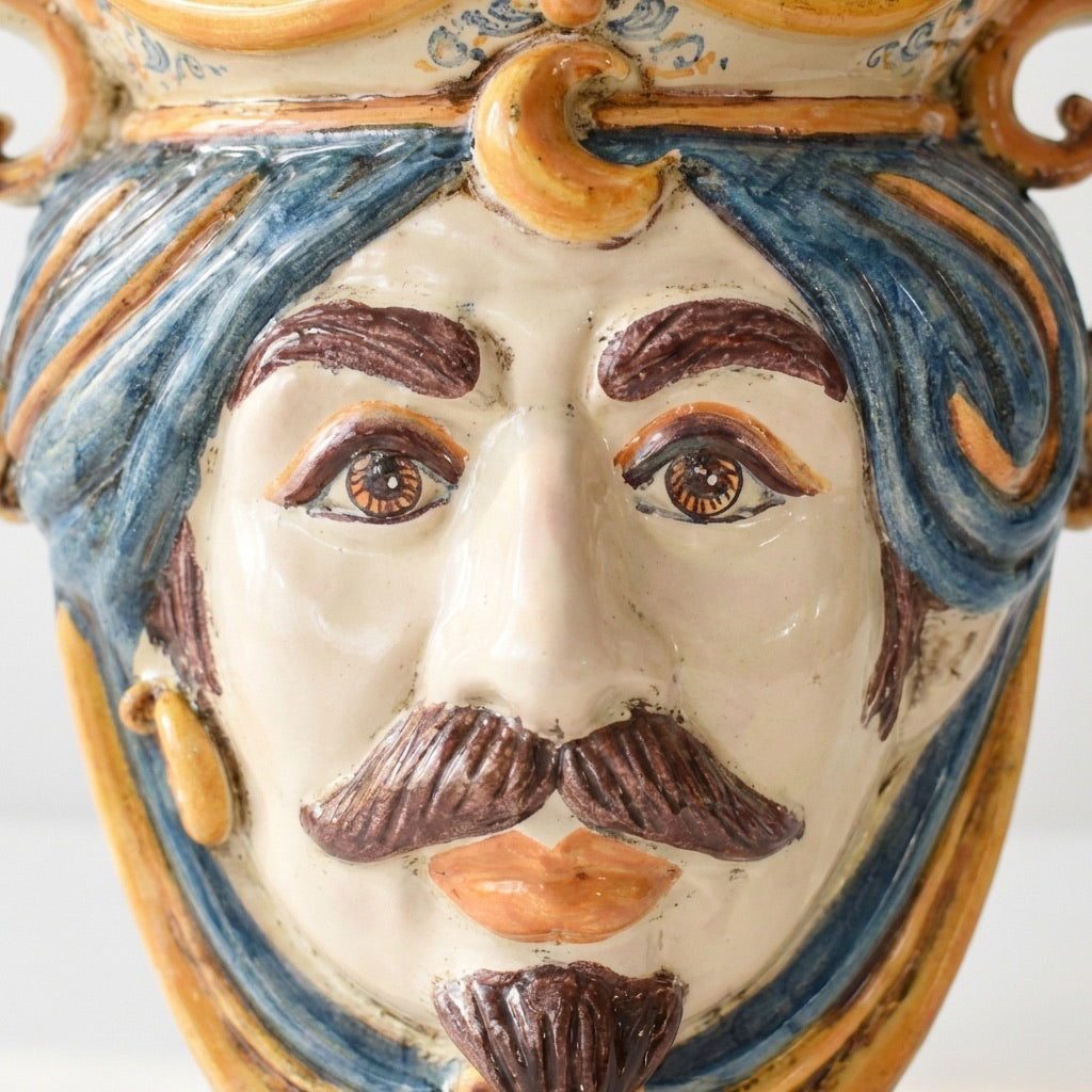 Handmade Teste di Moro ceramic face with blue hair, mustache, and crown, blending tradition and modern design