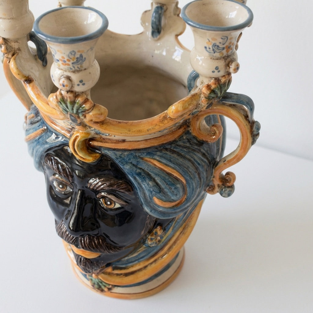 Handmade Teste di Moro ceramic vase with blue turban, floral details, and candle holders, blending tradition and modern design.