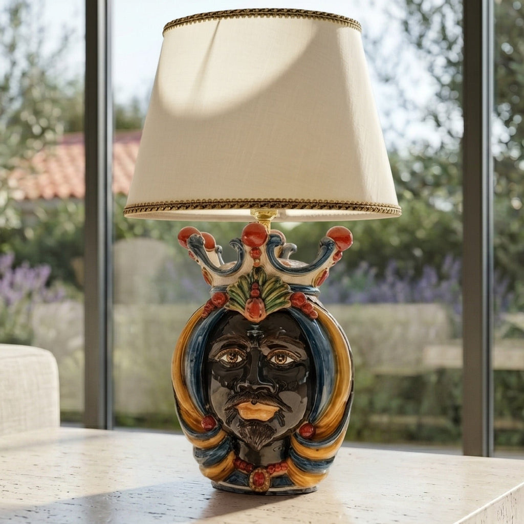 Handmade Teste di Moro table lamp with colorful ceramic face, crown, and beige shade, perfect for modern or traditional decor.