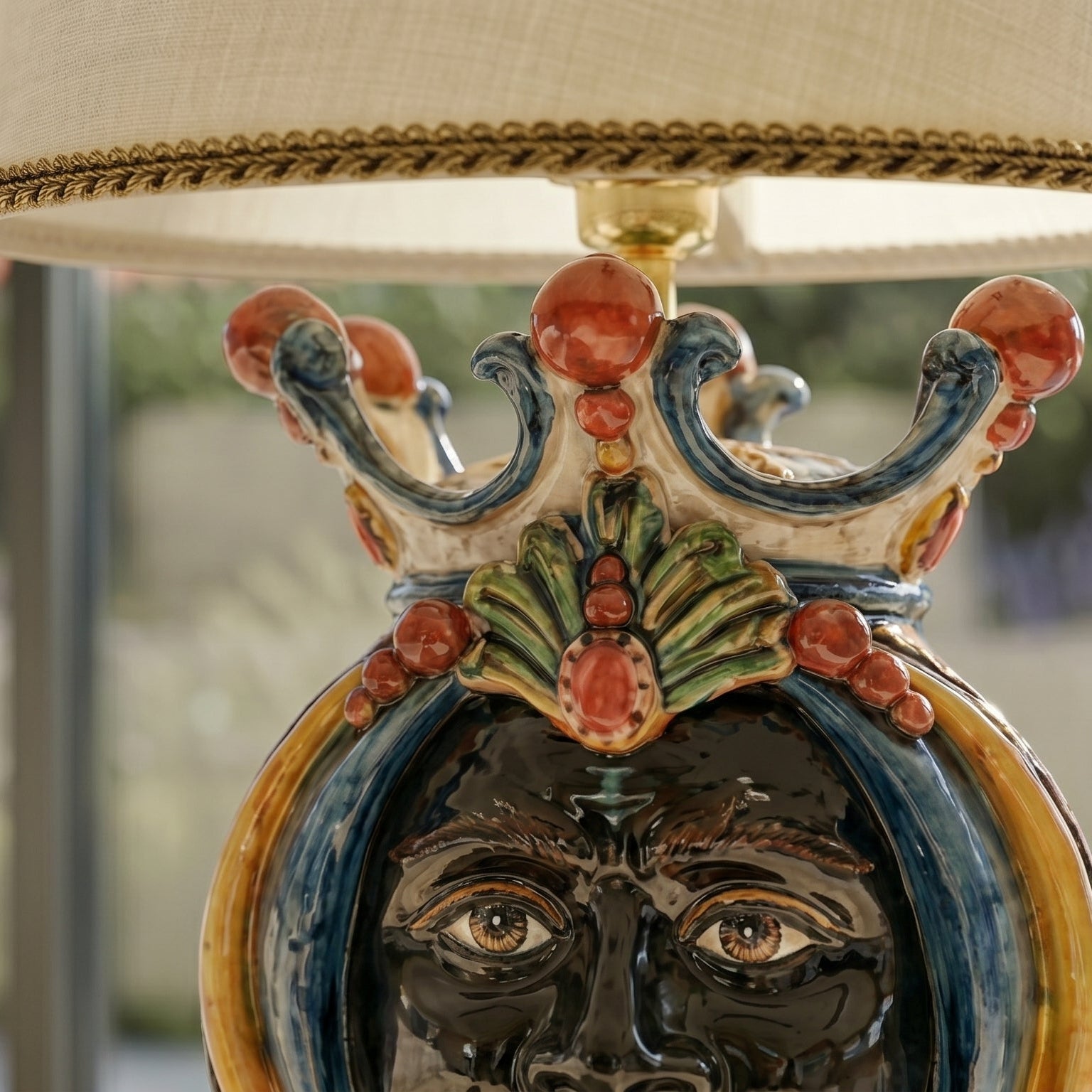 Handcrafted Teste di Moro table lamp with vibrant ceramic face, crown, and ornate details for modern-traditional decor