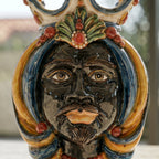 Handcrafted Teste di Moro ceramic vase with vibrant colors and detailed facial features, blending tradition and modern design.