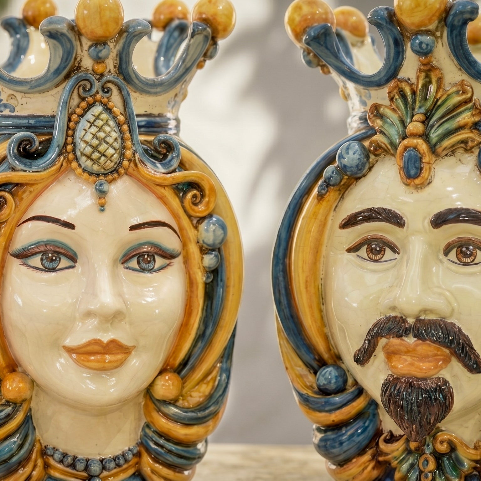 Handmade Sicilian Teste di Moro ceramic faces, ornate blue and gold design, traditional Italian decor
