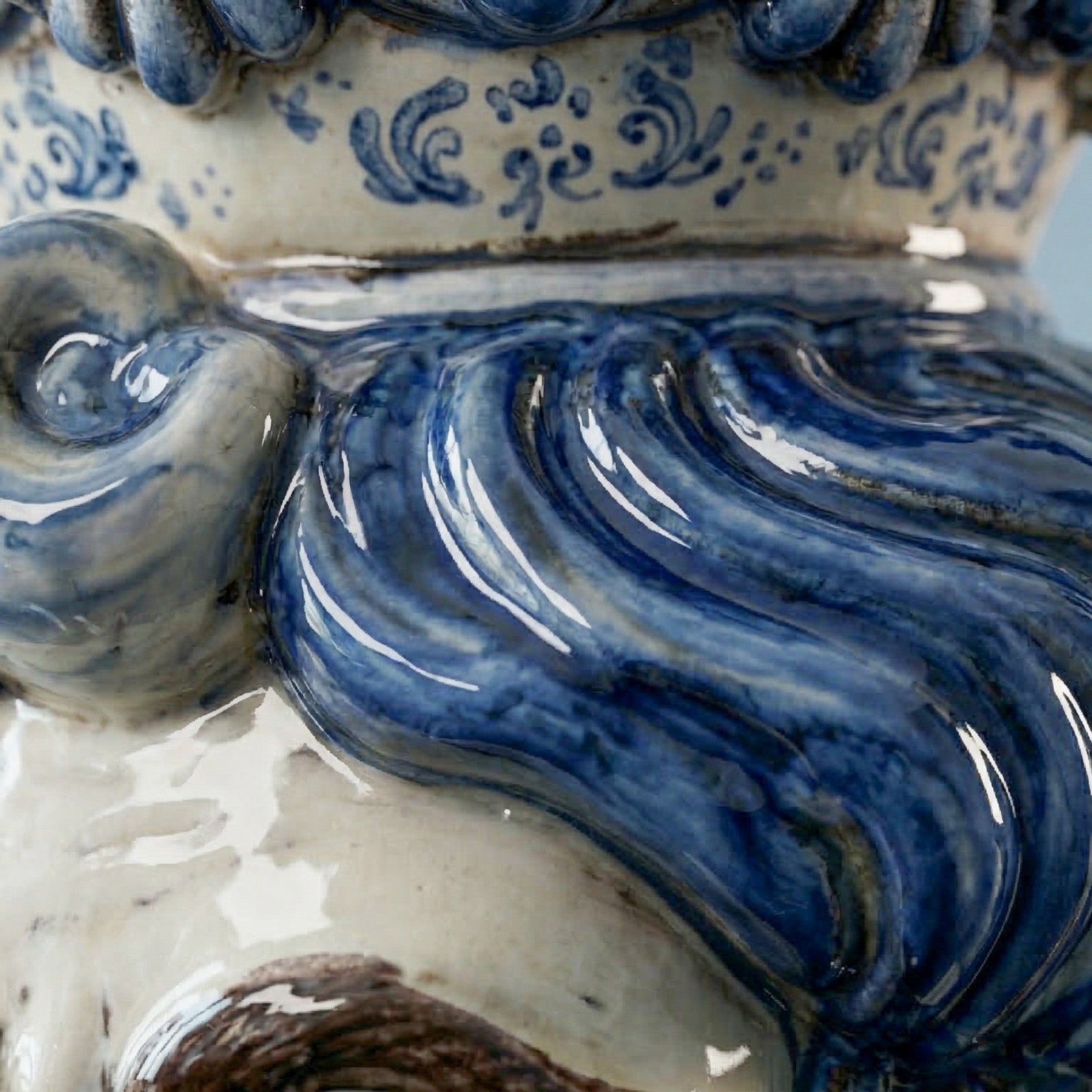 Close-up of handcrafted Teste di Moro ceramic with intricate blue glazed swirls and traditional patterns