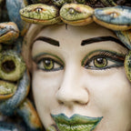 Close-up of the Medusa head: hand-painted green eyes and green lips