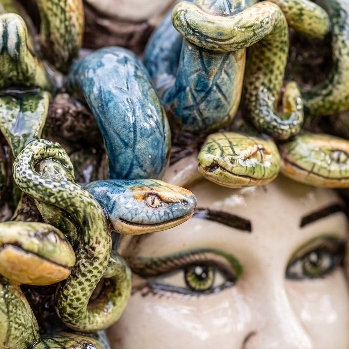 Detail of the green and blue snakes of the Medusa head, modelled one by one