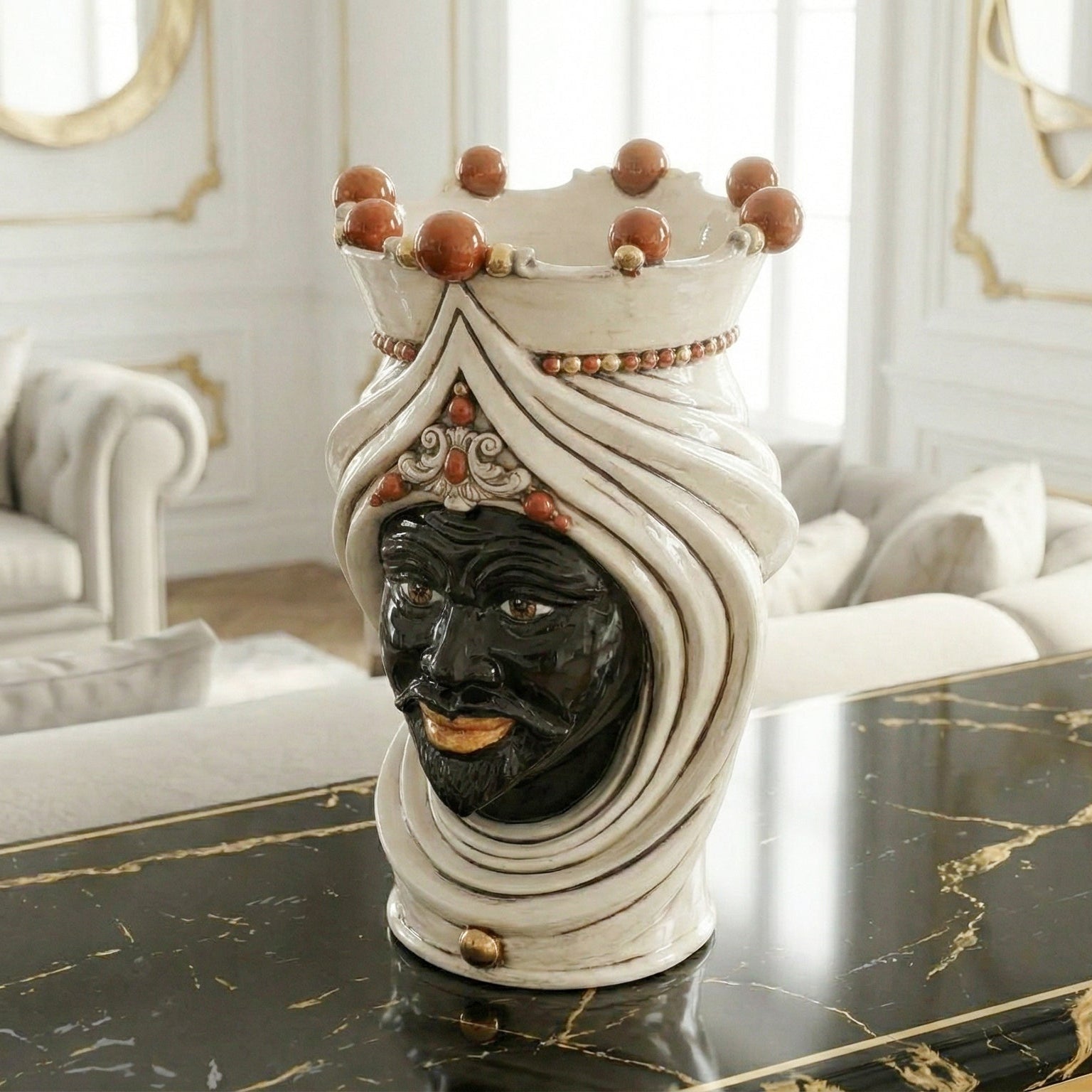 Handcrafted Teste di Moro ceramic vase with crown, black face, and white turban, displayed on marble table.