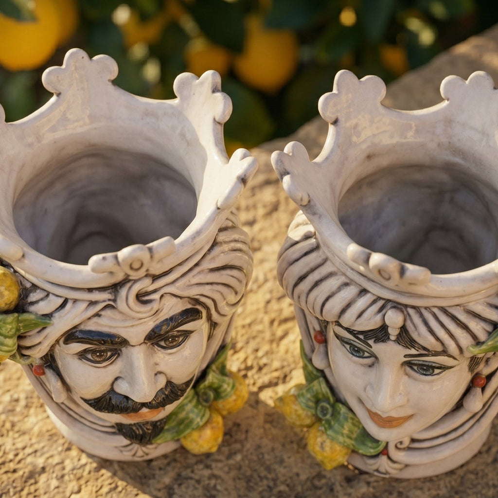 Handcrafted Teste di Moro ceramic vases with crowned Moorish faces, lemon accents, outdoor display