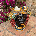 Handmade Sicilian Testa di Moro vase with crown, grapes, and vibrant colors, perfect for Mediterranean decor.