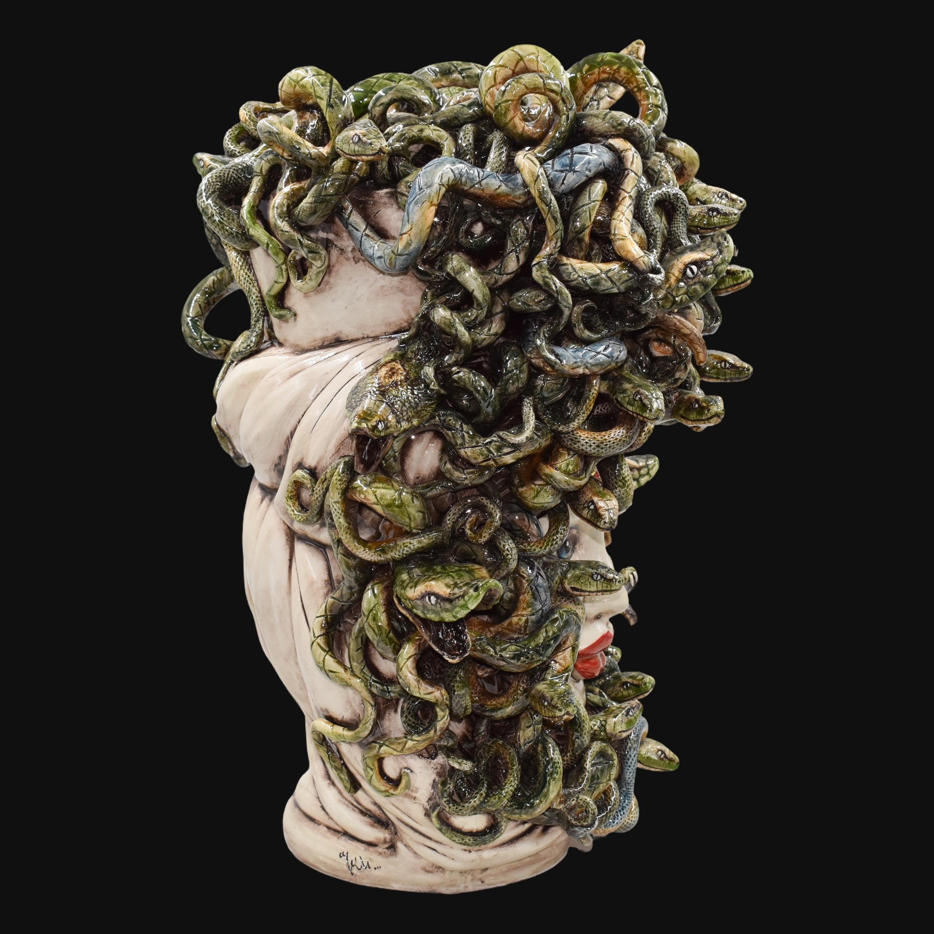 Handcrafted Medusa head sculpture with intricate green snakes, blending tradition and modern design.