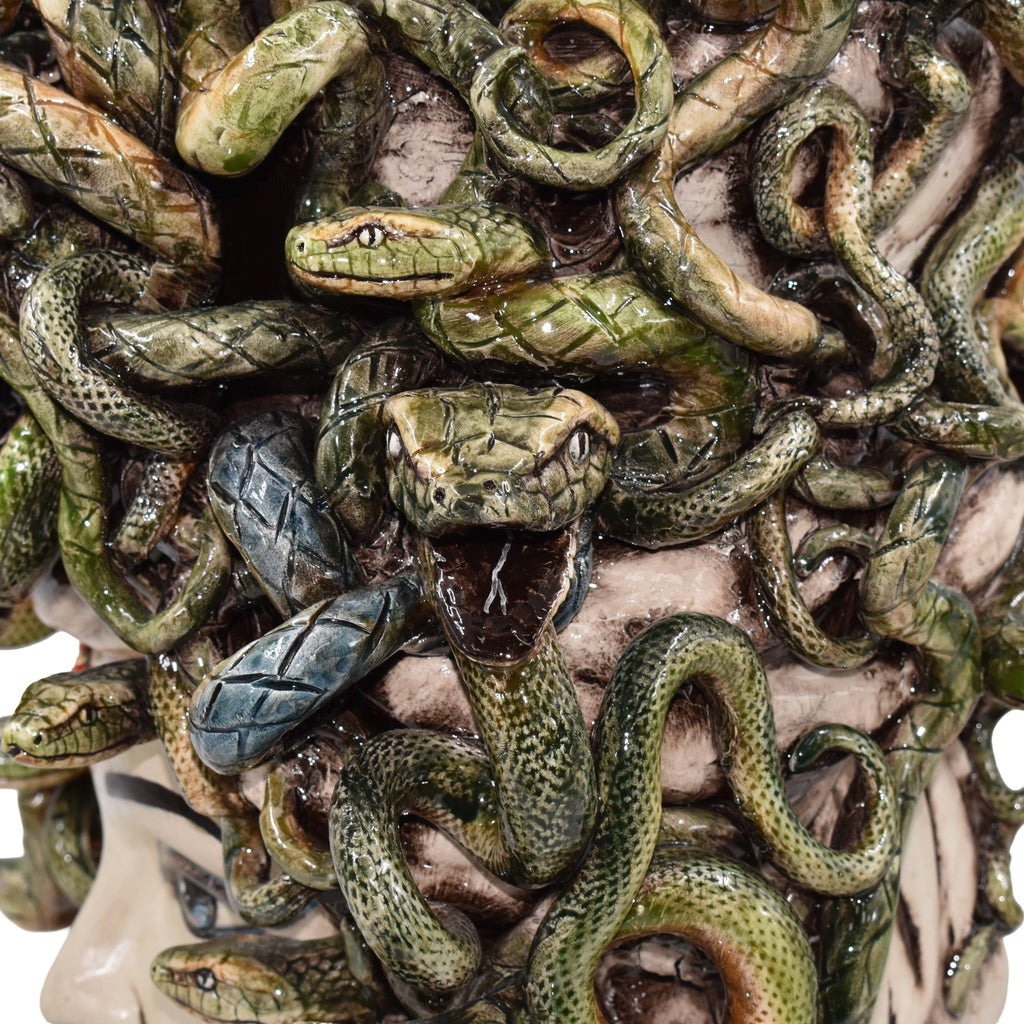 Handcrafted ceramic snake sculpture with intricate green scales, coiled design, and detailed textures for modern decor