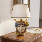 Handcrafted Sicilian Testa di Moro table lamp with colorful ceramic face, lemon accents, and white shade on wood surface