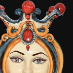 Handcrafted Teste di Moro ceramic with ornate crown, vibrant red and blue details, traditional Sicilian design