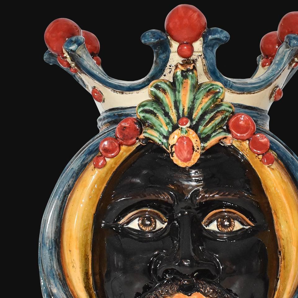 Handcrafted Teste di Moro ceramic face with crown, vibrant colors, traditional Sicilian design