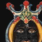Handcrafted Teste di Moro ceramic face with crown, vibrant colors, traditional Sicilian design