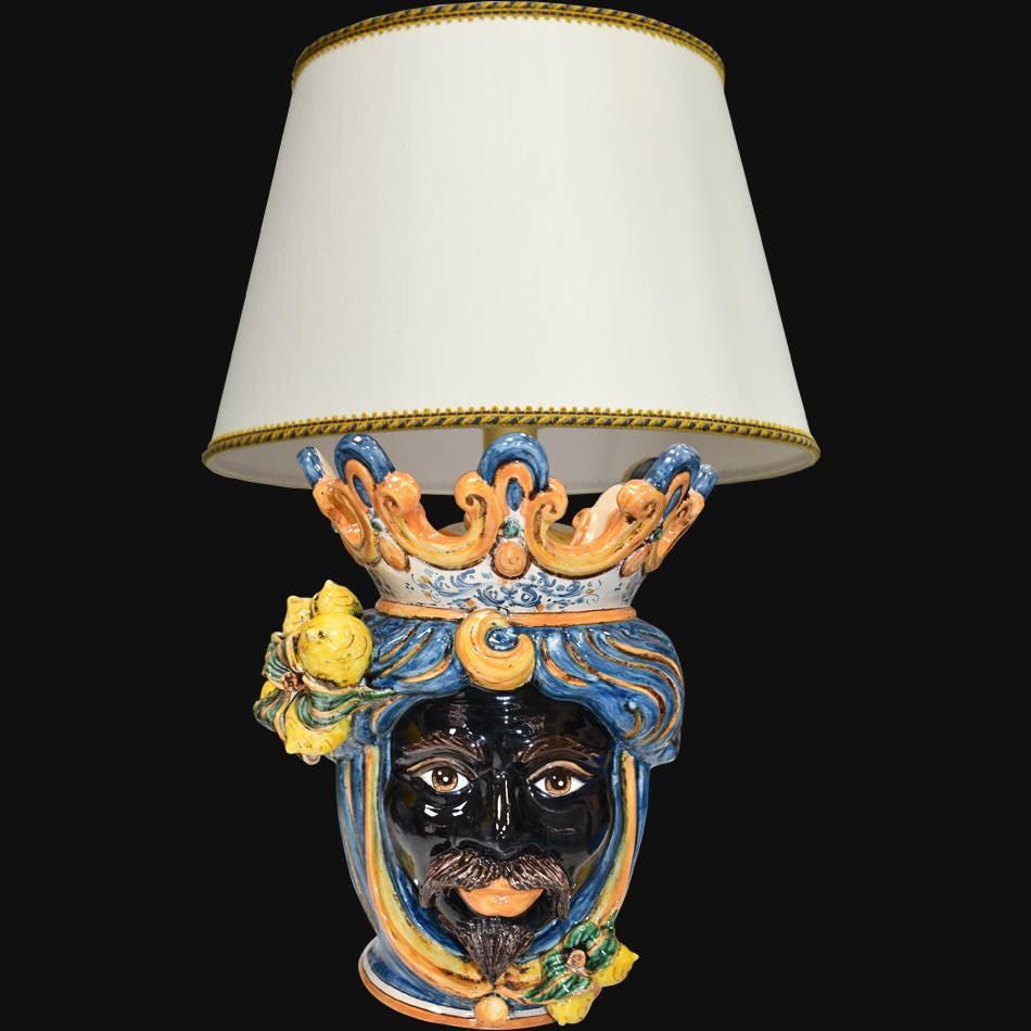 Handcrafted Teste di Moro lamp with colorful ceramic face, crown, and lemon accents, blending tradition and modern design.