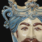 Handcrafted Teste di Moro ceramic face with blue turban, detailed eyes, and mustache, blending tradition and modern design