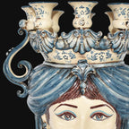 Handmade Teste di Moro ceramic candelabra with blue and cream floral details, ornate crown, and expressive eyes.
