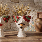Handmade Teste di Moro vase with red roses, mustache, and dried wheat, blending tradition and modern design.