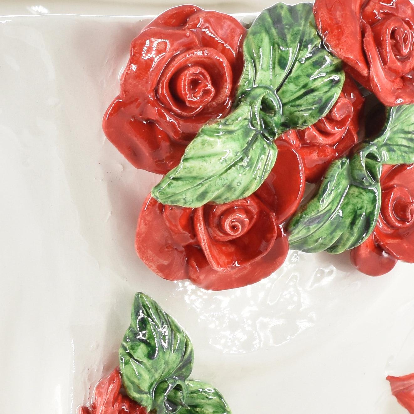 Handcrafted ceramic roses with green leaves, glossy finish, decorative wall art