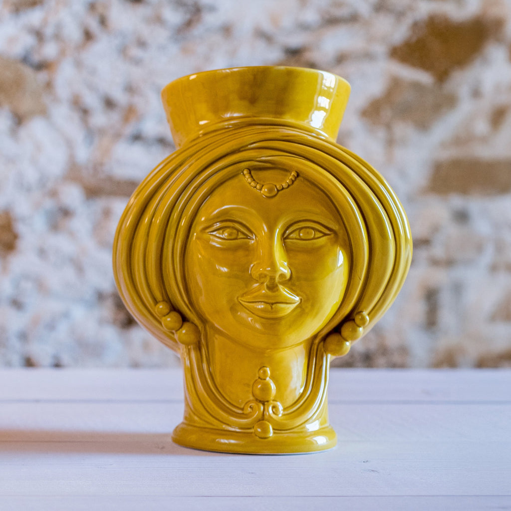 Handmade yellow Teste di Moro vase with ornate face design, blending tradition and modern decor