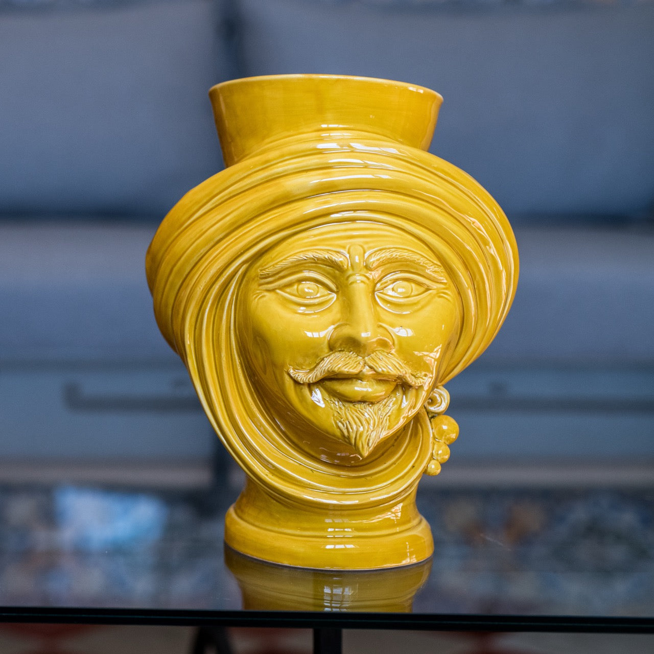 Yellow ceramic Teste di Moro vase with turban, mustache, and beard, blending tradition and modern design.