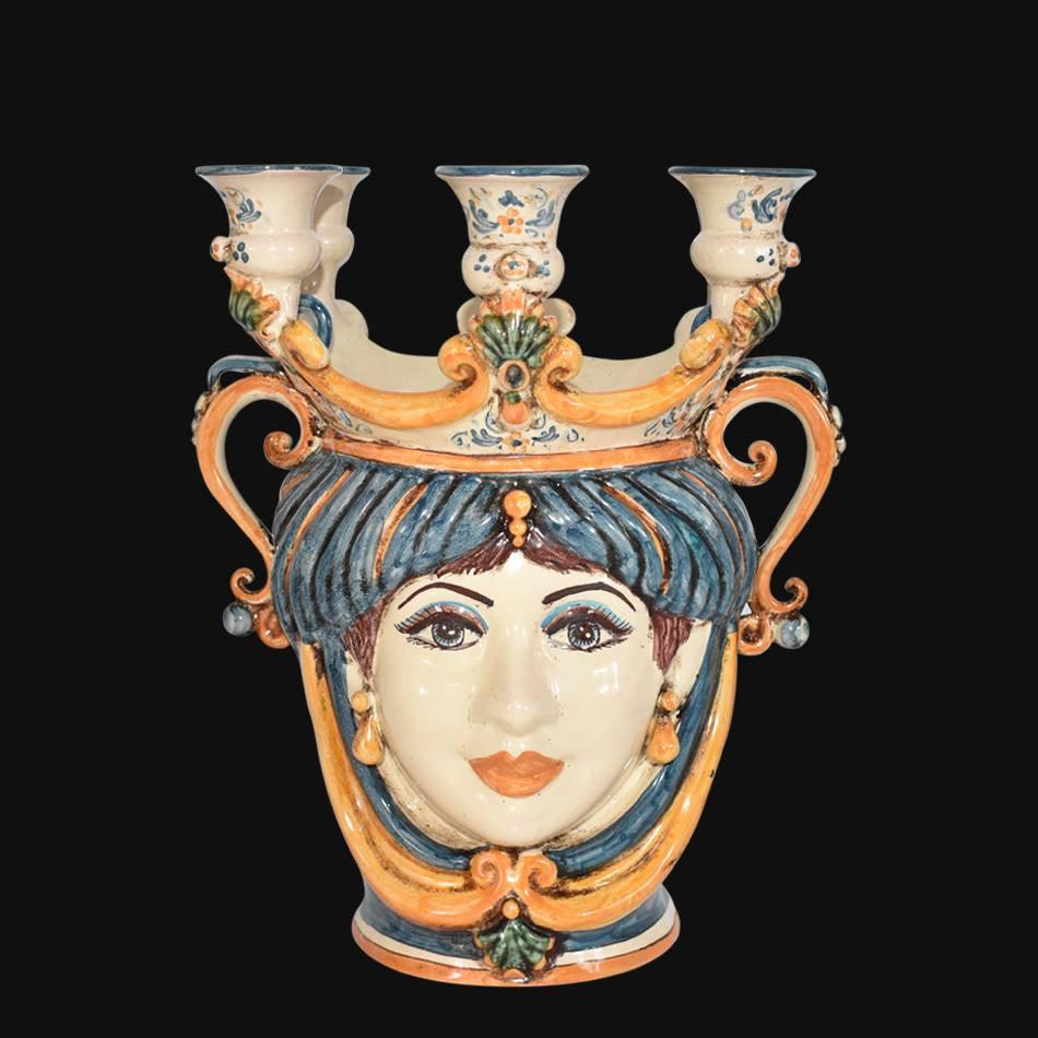 Handmade ceramic Teste di Moro candle holder with ornate face, blue hair, and three arms, blending tradition and modern design