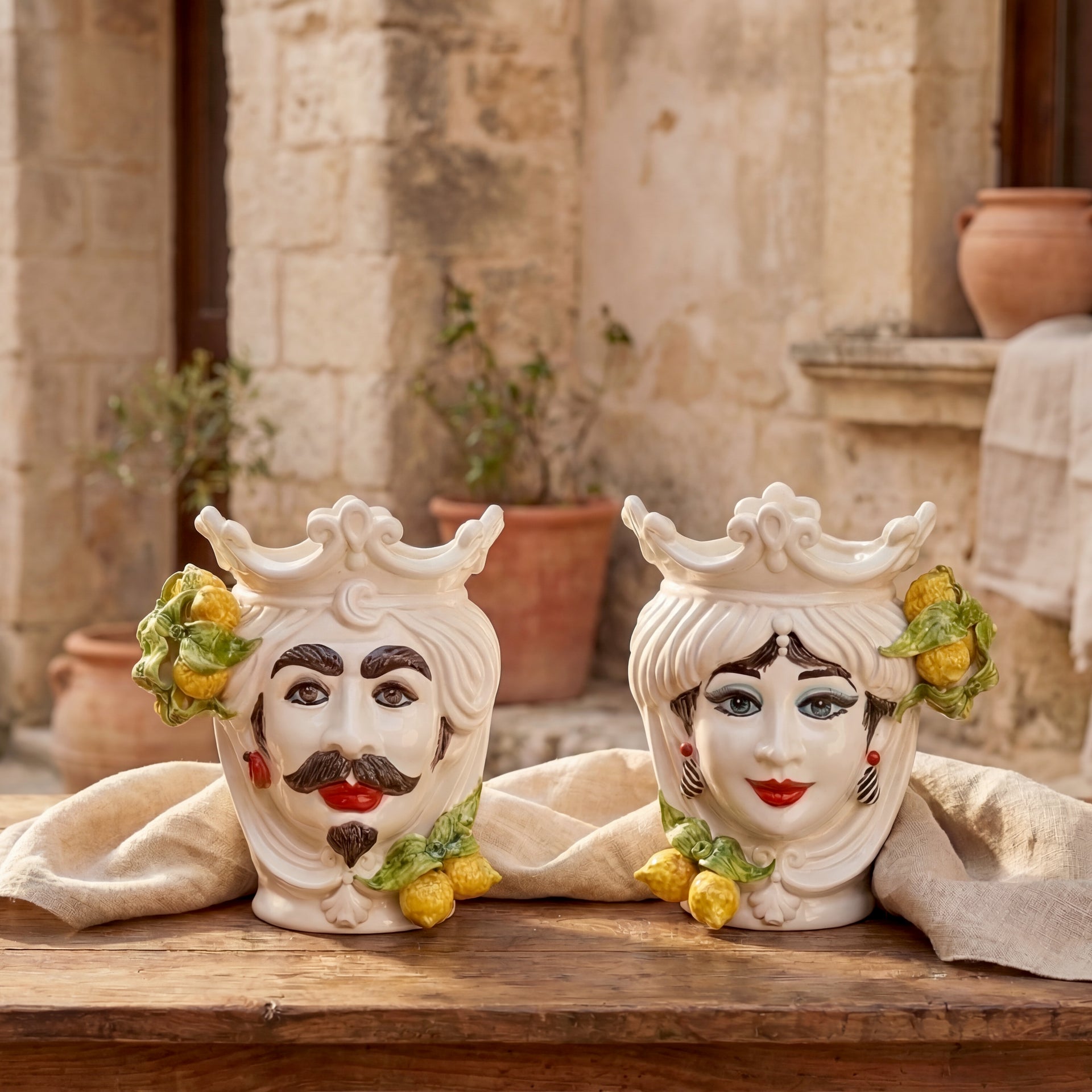 Pair of handcrafted ceramic Teste di Moro heads with crown and lemon decorations.