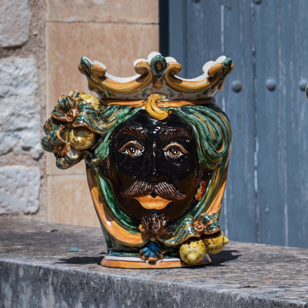 Handcrafted Teste di Moro ceramic vase with crown, green hair, and vibrant colors, blending tradition and modern design.