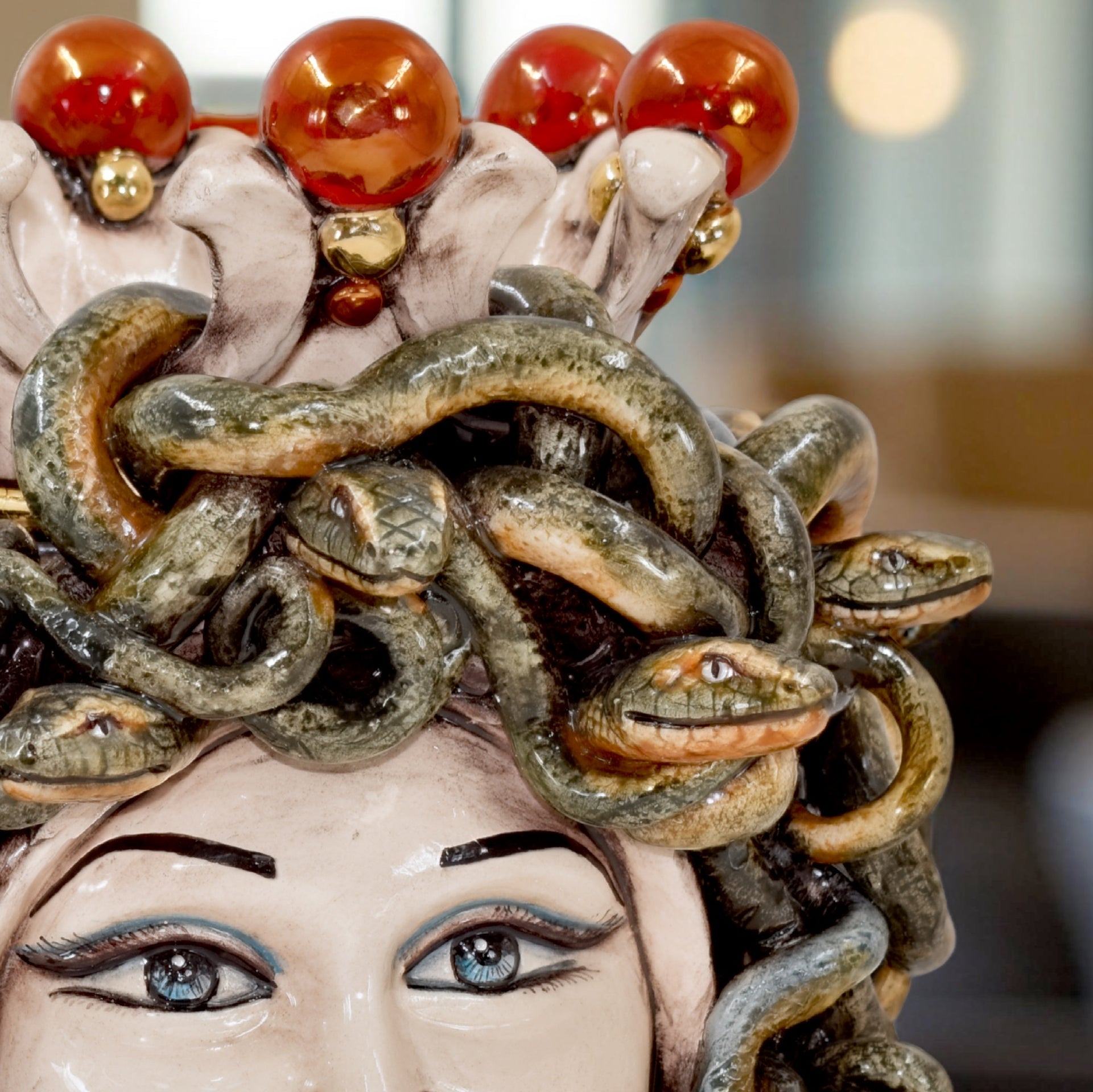 Handcrafted Teste di Moro ceramic with snake hair and amber beads, blending tradition and modern design.