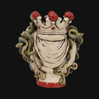 Handcrafted ceramic vase with crown and green snakes, red accents, blending tradition and modern design