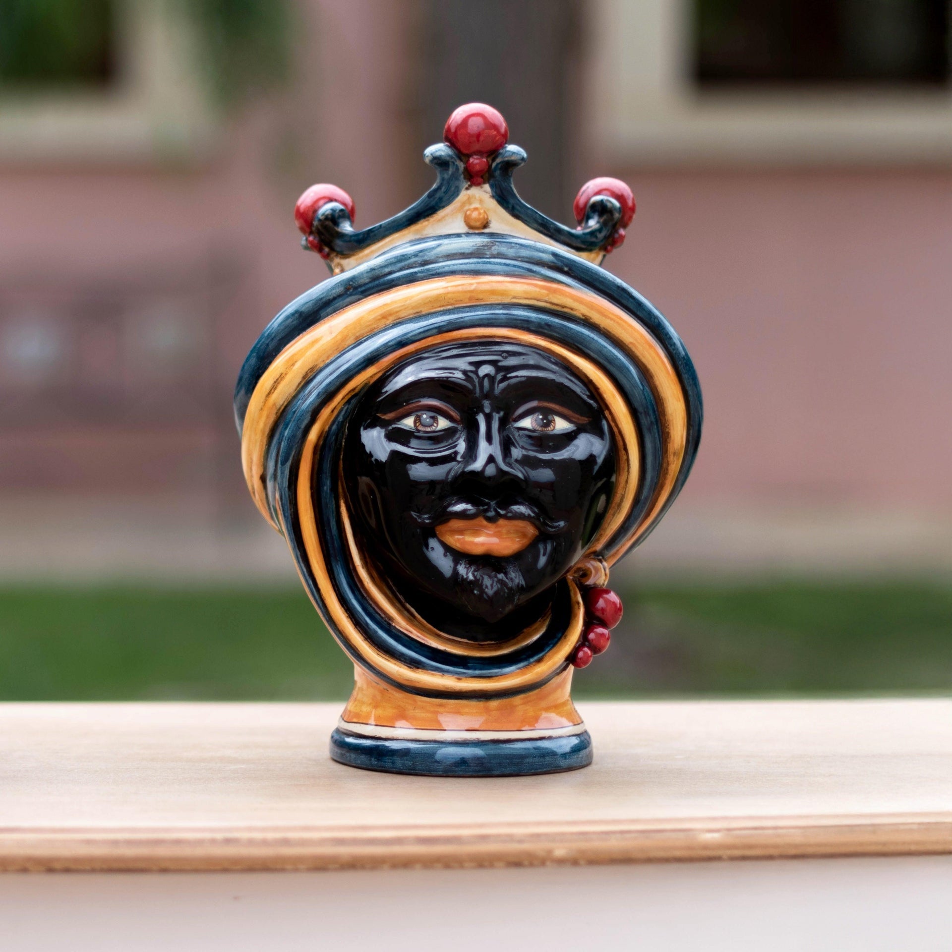 Handmade Teste di Moro ceramic sculpture with vibrant blue, gold, and red details, showcasing traditional Sicilian artistry.