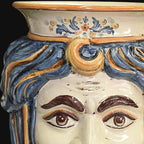 Handcrafted Teste di Moro ceramic vase with blue and gold hair, detailed eyes, and floral motifs