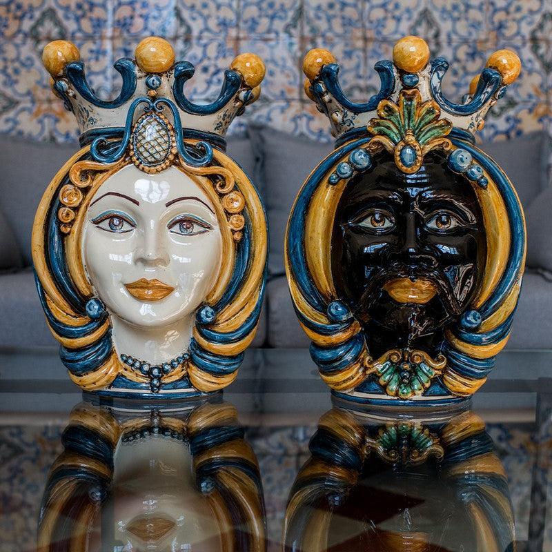 Handcrafted Teste di Moro ceramic sculptures with vibrant blue, gold, and white glazes, showcasing traditional Sicilian artistry.