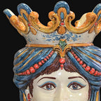Handcrafted Teste di Moro ceramic with ornate blue crown, red beads, and expressive eyes, blending tradition and modern design.