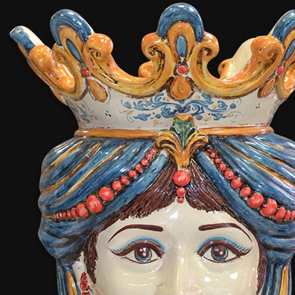 Handcrafted Teste di Moro ceramic with ornate blue crown, red beads, and expressive eyes, blending tradition and modern design.