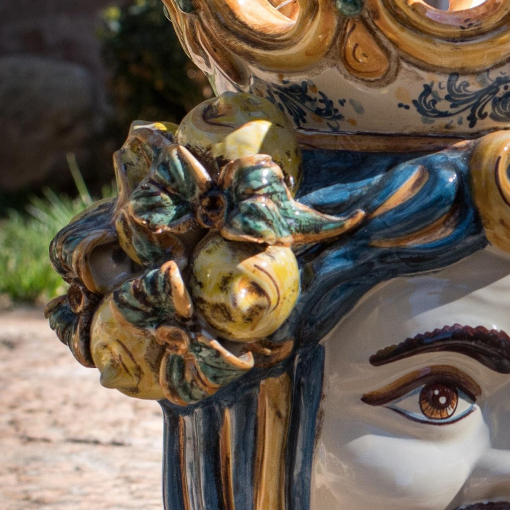 Handcrafted Teste di Moro ceramic with vibrant blue hair, floral crown, and detailed eye, blending tradition and modern design.