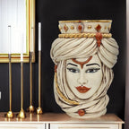 Handmade Teste di Moro ceramic vase with ornate turban, gold accents, and gem details, styled on a console table.