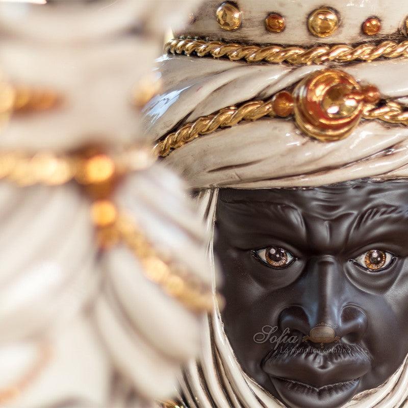 Handcrafted Teste di Moro ceramic with ornate white turban and gold accents, blending tradition and modern design.