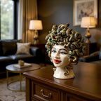 Handmade Teste di Moro ceramic sculpture with snake hair, displayed on wooden dresser in elegant living room